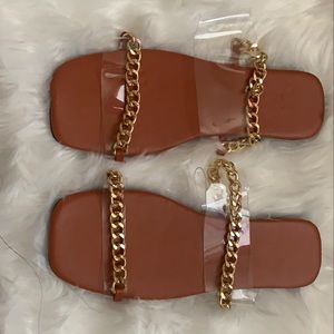Pretty brown flat sandals with gold straps.
